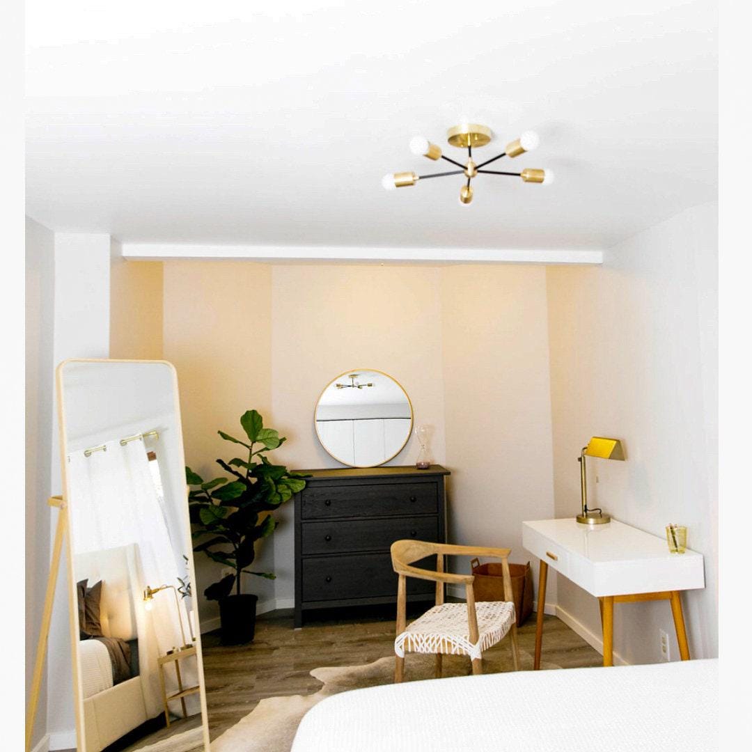 Mid-century modern chandelier with raw brass finish and nine exposed bulbs in living room setting. - CHANDELIER MODEL NO. 6652