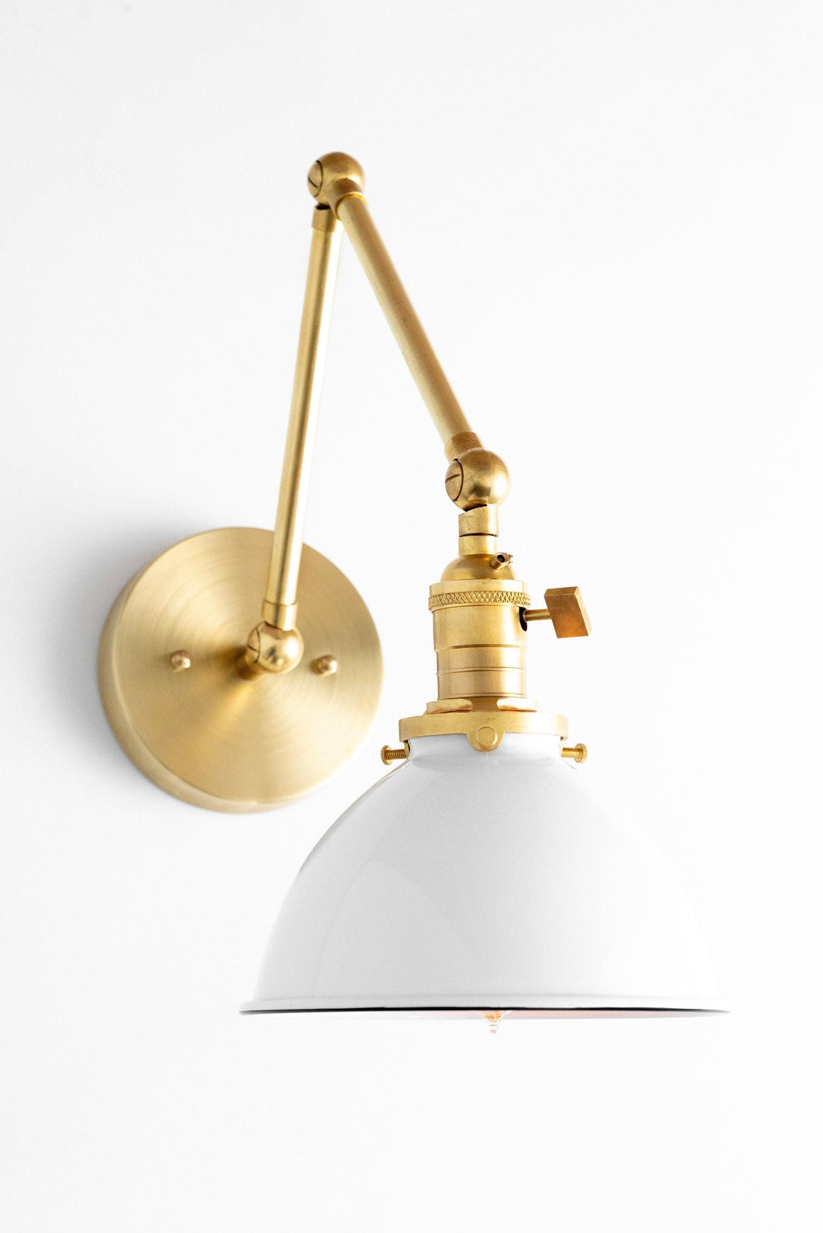 Mid-century modern adjustable wall sconce with raw brass finish and white metal shade. - SCONCE MODEL NO. 8551