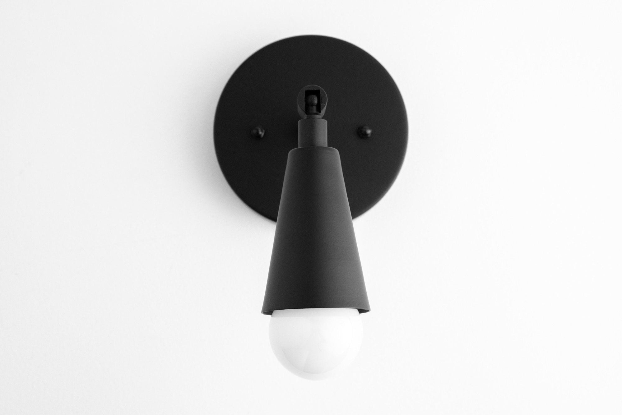 Black mid-century modern wall sconce with adjustable conical shade and exposed bulb. - SCONCE MODEL NO. 4339