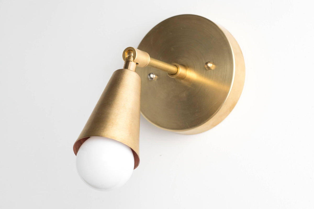 Mid-century modern raw brass adjustable wall sconce with exposed bulb and conical shade. - SCONCE MODEL NO. 4339