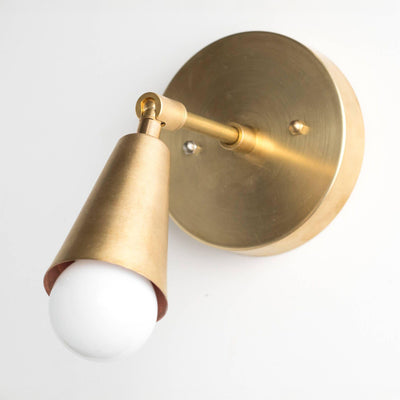 Mid-century modern raw brass wall sconce with adjustable conical shade and exposed bulb. - SCONCE MODEL NO. 4339