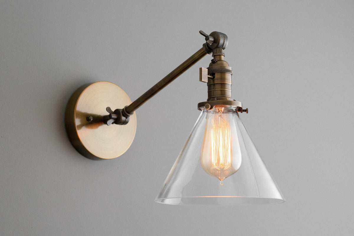 Mid-century modern adjustable wall sconce with raw brass finish and clear conical glass shade. - SCONCE MODEL NO. 7962