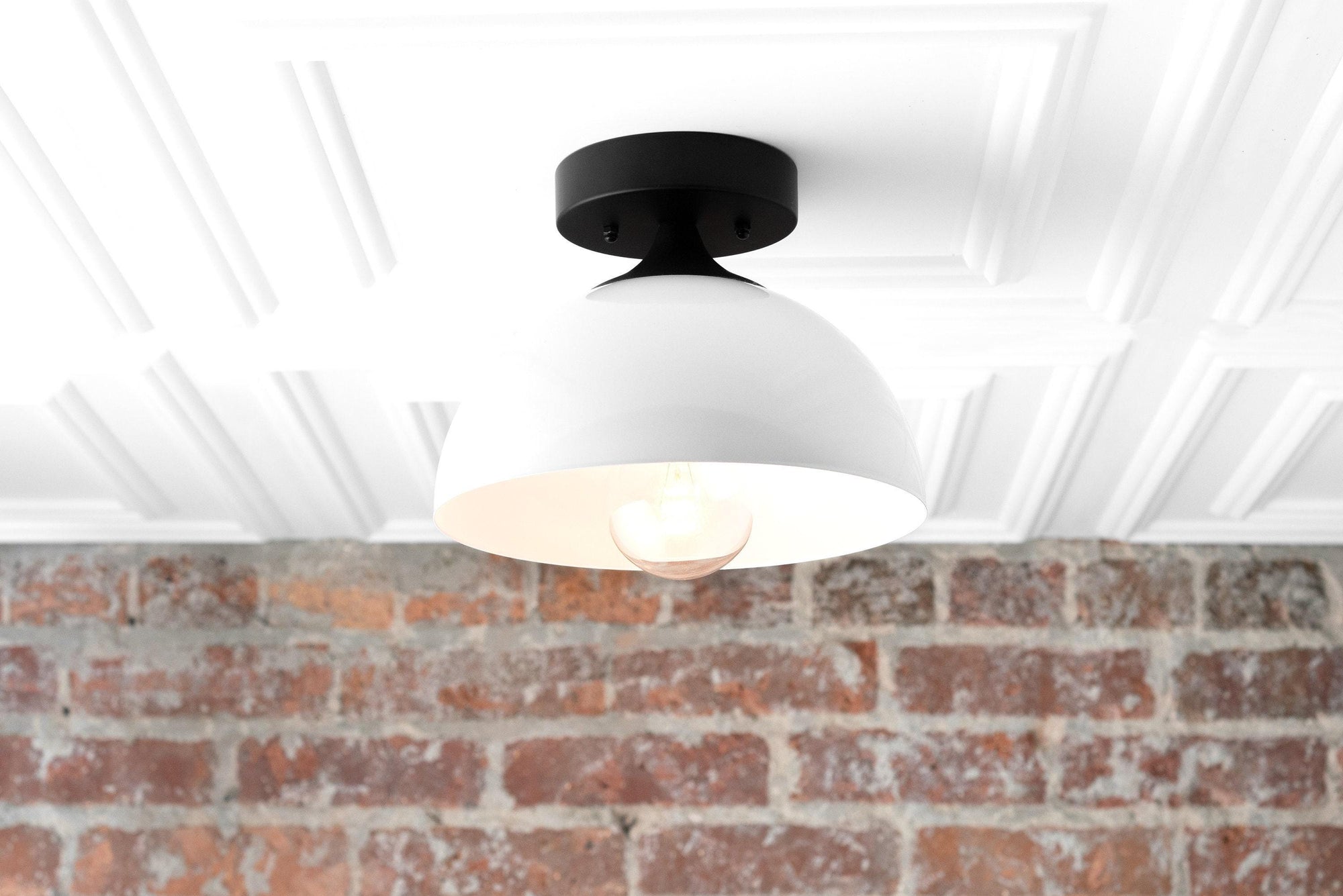 Semi-flush ceiling light with matte black fixture and white dome shade over exposed bulb, mounted on white ceiling with. - CEILING LIGHT MODEL NO. 8510