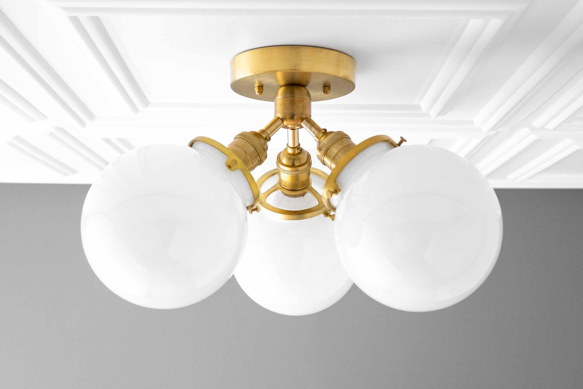 Mid-century modern flush mount ceiling light with three white globe shades and raw brass finish. - CEILING LIGHT MODEL NO. 0210
