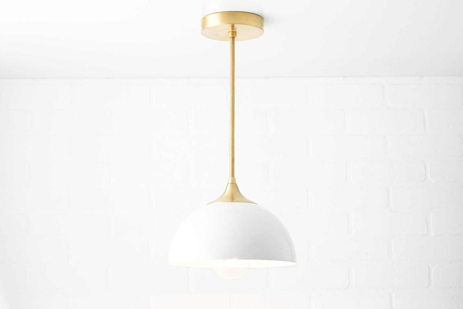 Mid-century modern pendant light with white dome shade and sealed brass mount and rod. - PENDANT MODEL NO. 9263