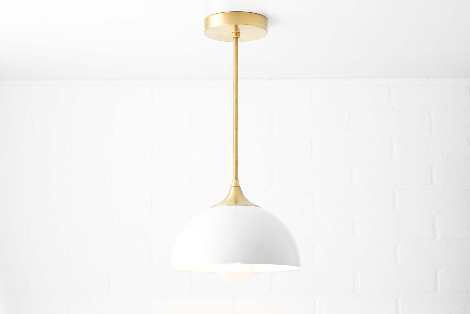 Mid-century modern pendant light with white dome shade and sealed brass mount and rod. - PENDANT MODEL NO. 9263