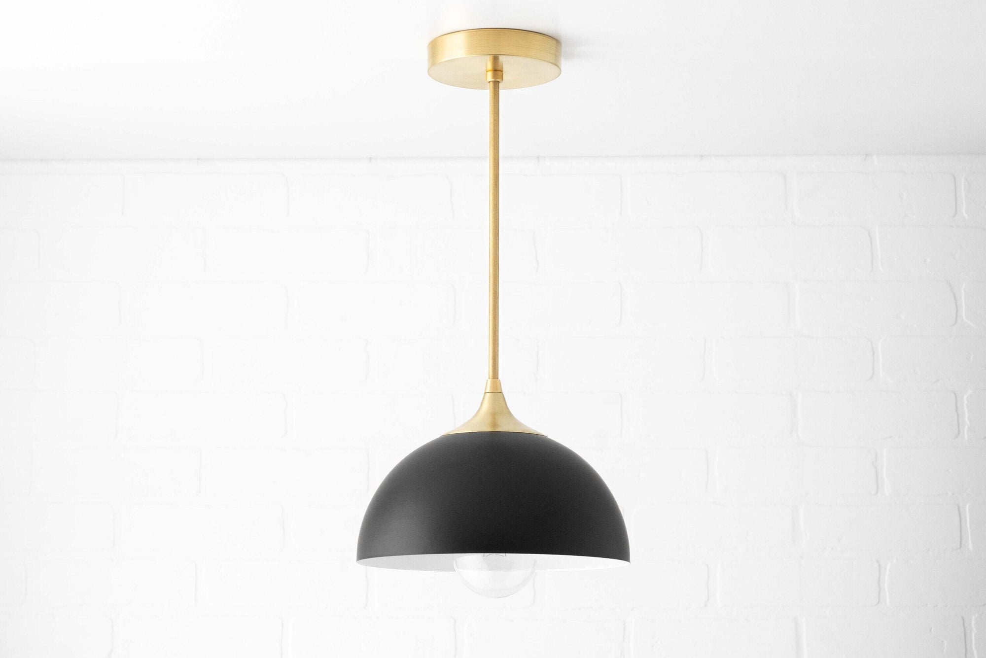 Mid-century modern pendant light with matte black dome shade and brass suspension rod. - PENDANT MODEL NO. 9263