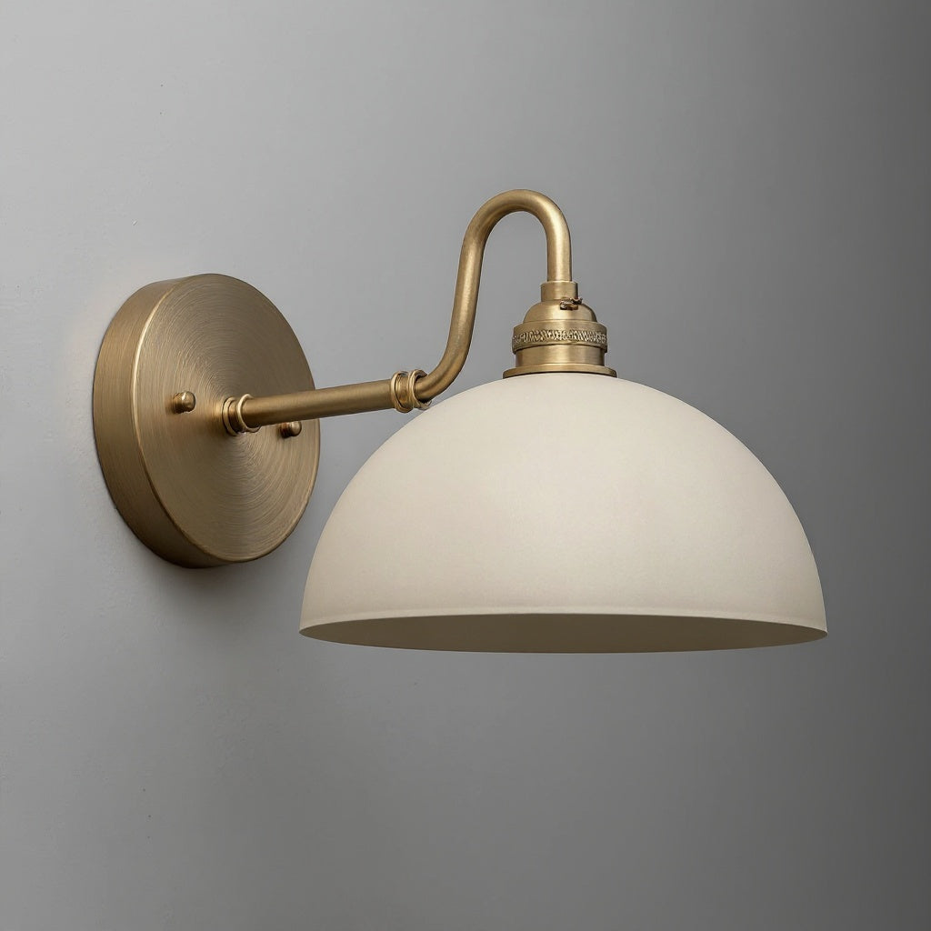 Wall sconce with antique brass curved arm and matte cream dome-shaped shade. - SCONCE MODEL NO. 9103