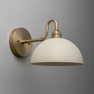 Wall sconce with antique brass curved arm and matte cream dome-shaped shade. - SCONCE MODEL NO. 9103
