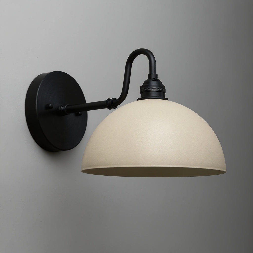 Black metal wall sconce with curved arm and smooth cream dome-shaped shade. - SCONCE MODEL NO. 9103