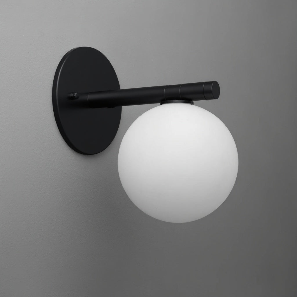 Black wall sconce with round backplate and frosted white glass globe shade. - SCONCE MODEL NO. 0904