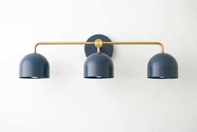 Mid-century modern vanity light with three deep blue metal shades and a raw brass horizontal bar. - VANITY LIGHT MODEL NO. 7456