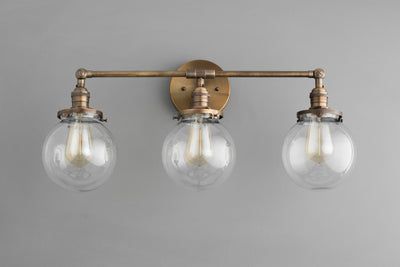 VANITY MODEL No. 3170- Industrial bathroom lighting with a Antique Brass finish. Designed and produced by newwineoldbottles at Peared Creation