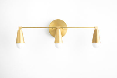 VANITY MODEL No. 9945- Mid Century Modern bathroom lighting with a Raw Brass finish. Designed and produced by MODCREATIONStudio at Peared Creation