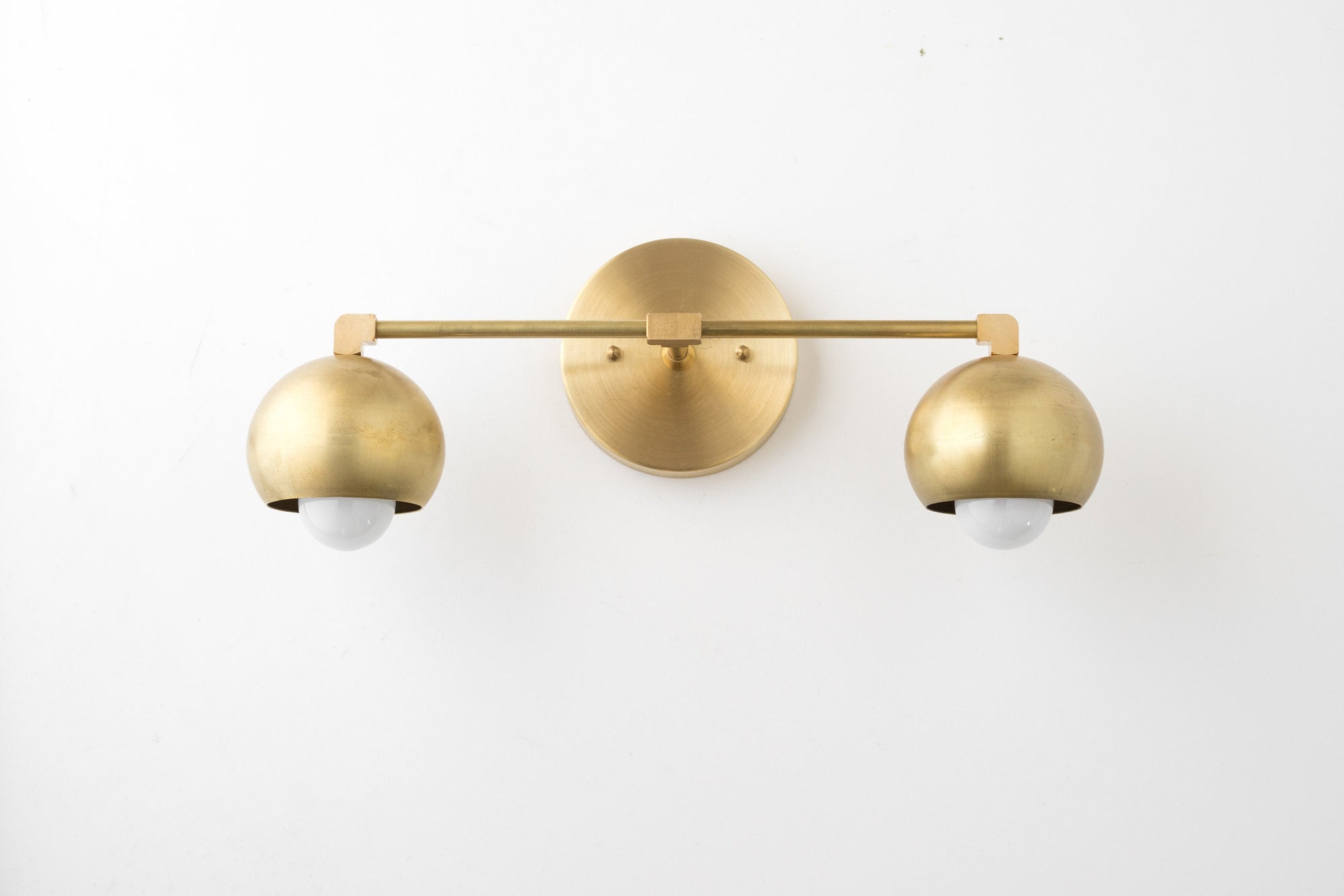 Mid-century modern double vanity light with raw brass finish and globe glass bulbs. - VANITY LIGHT MODEL NO. 5469