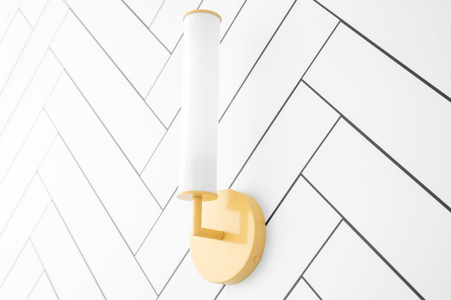 Modern yellow wall sconce with cylindrical white glass shade and round backplate on white herringbone tile wall. - SCONCE MODEL NO. 6612
